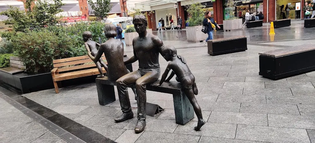Family statue on a bench.
